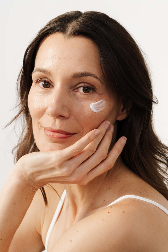 braunhaarige Frau hatt einen Klecks JACKS beauty line Night Cream auf der Wange