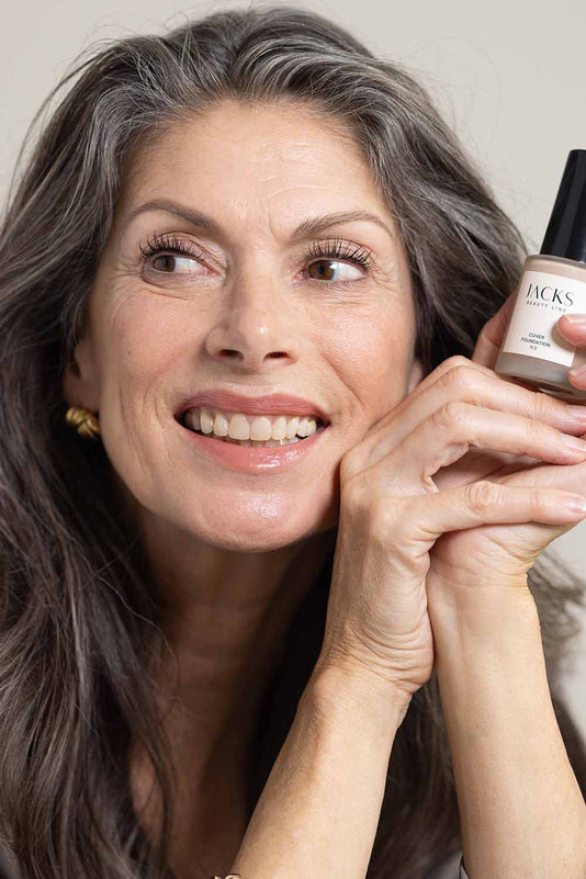 #farbwunsch_n-3, geschminkte Frau mit JACKS beauty line Cover Foundation N.3 in der Hand