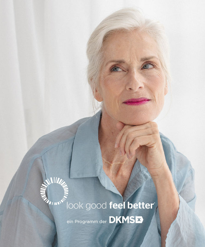 Ältere Frau trägt den limitierten pinken Lippenstift aus der DKMS Kollaboration