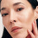 schwarzhaarige Frau trägt den JACKS beauty line Cream Highlighter auf den Wangen