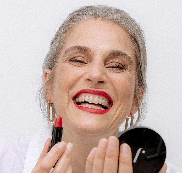 Frau lächelt und trägt den JACKS beauty line Lipstick in Orange Red auf den Lippen